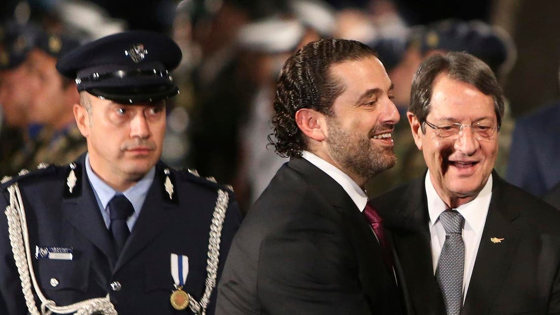 Lebanese Prime Minister Saad Hariri, center, and Cyprus President Nicos Anastasiades smile after they review a military guard of honor during the welcoming ceremony before a meeting at the presidential palace in Nicosia, Cyprus, on Saturday, Oct. 28, 2017. (AP)