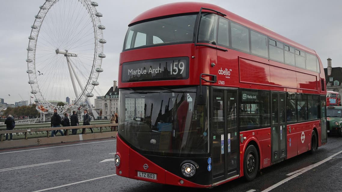 A red London double-decker bus passes the London Eye as it is driven over Westminster Bridge in central London on November 20, 2017. (AFP)