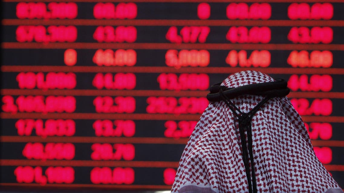 A Qatari investor follows the stock market activity at the Doha Securities Market on December 1, 2009. (AFP)