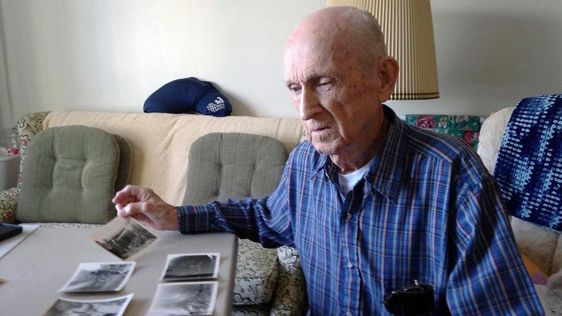 World War II veteran Kenneth F. Lincoln, 90, looks at photos in his North Attleborough, Mass., home that were taken when he was serving in the U.S. Navy. (AP)