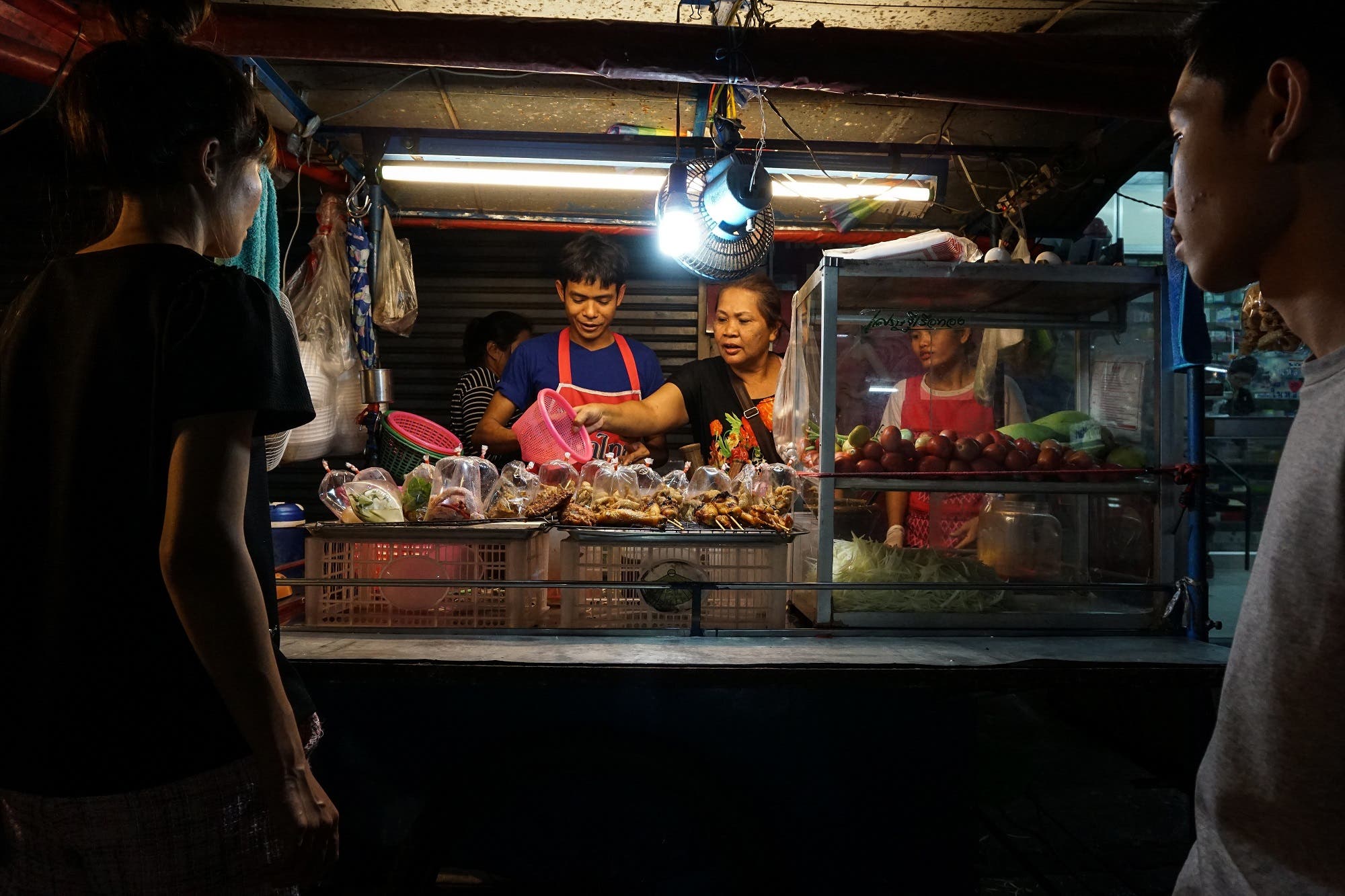 This April 17, 2017 photo shows a family preparing food for customers at a street food stall in the Phrakanong district of Bangkok. (AFP)