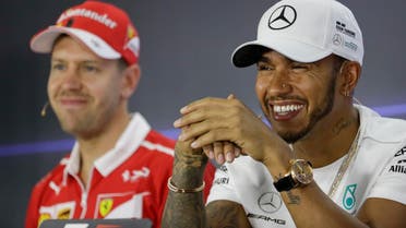 Mercedes driver Lewis Hamilton of Britain (right) sits next to Ferrari driver Sebastian Vettel of Germany during a news conference at the Yas Marina racetrack in Abu Dhabi, UAE, on Nov. 23, 2017. (AP)