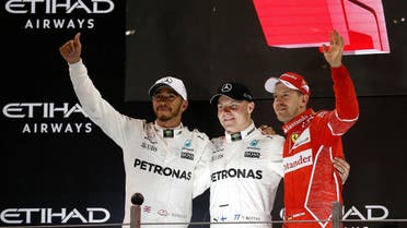 Mercedes’ Valtteri Bottas (C) celebrates winning the race as Mercedes’ Lewis Hamilton (L) finished second and Ferrari’s Sebastian Vettel (R) third. (Reuters)