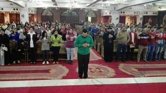 Egyptian Copts pray for victims of mosque attack in emotional photo