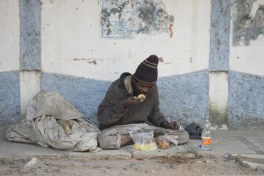 An Indian beggar eats food on the side of the road in Hyderabad on November 10, 2017. The city banned begging in public places ahead of a three-day summit that Ivanka Trump is due to attend, police said November 10. (AFP)