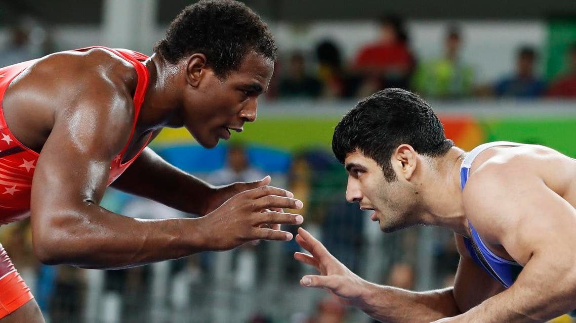 This file photo taken on August 20, 2016 shows USA's J'den Michael Tbory Cox (red) wrestling with Iran's Alireza Mohammad Karimimachiani in their men's 86kg freestyle quarter-final match. (AFP)