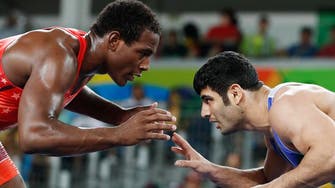 Iranian wrestler says managers told him to throw match