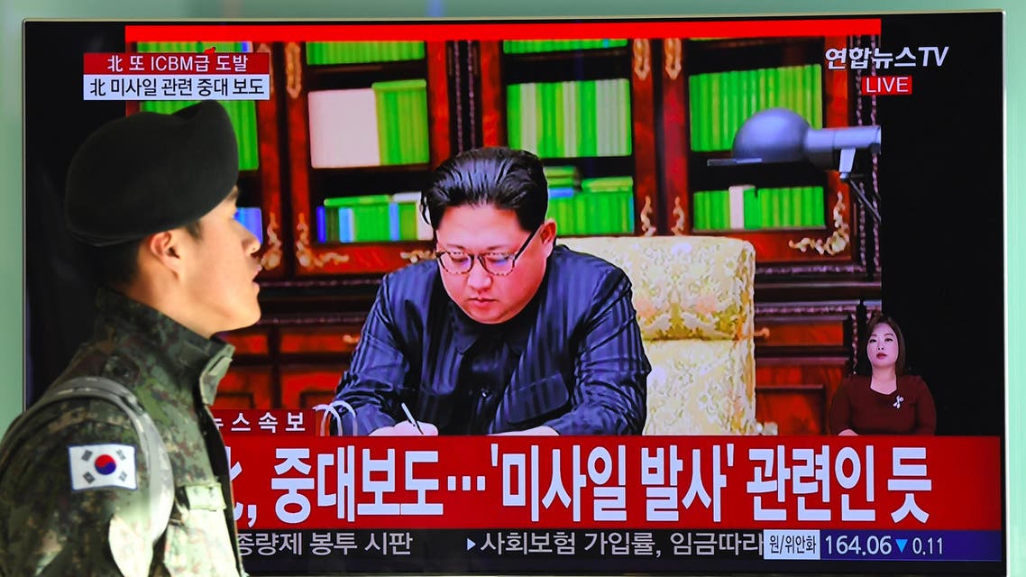 A South Korean soldier walks past a television news screen showing North Korean leader Kim Jong-Un approving the country's new ICBM test, at a railway station in Seoul on November 29, 2017 Nuclear-armed North Korea said on November 29 it had successfully tested a new intercontinental ballistic missile that put "all of the US continent" within its range. JUNG Yeon-Je / AFP