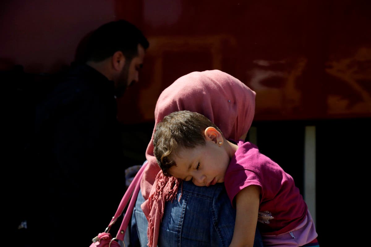 A woman with her child migrant from Syria walk towards a refugee camp at Kokkinotrimithia, outside of the capital Nicosia, in the eastern Mediterranean island of Cyprus, on Sunday, Sept. 10, 2017. (AP)