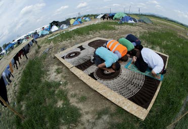 Muslims pray at a makeshift camp for migrants and refugees near the village of Idomeni not far from the Greek-Macedonian border on May 1, 2016. (AFP)