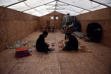 Yazidi refugees sit in a makeshift accommodation turned into a classroom at the Serres refugee camp, northern Greece, on November 24, 2017. (AFP)