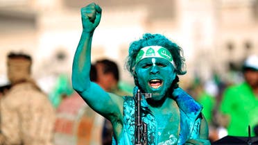 A Muslim Yemeni, covered with green paint, chants slogans as he attends a rally in the capital Sanaa on the occasion of the Prophet Mohammed's birthday on November 30, 2017. (AFP)