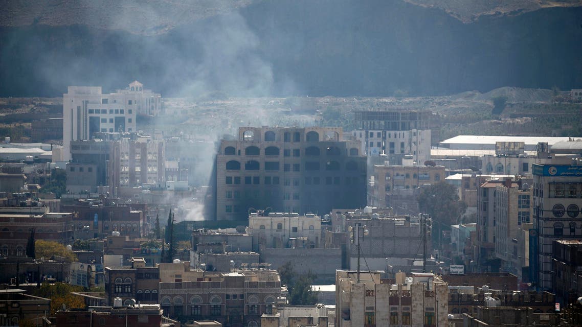 Smoke billows behind a building in the Yemeni capital Sanaa on December 3, 2017, during clashes between Huthi rebels and supporters of Yemeni ex-president Ali Abdullah Saleh. AFP
