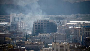 Smoke billows behind a building in the Yemeni capital Sanaa on December 3, 2017, during clashes between Huthi rebels and supporters of Yemeni ex-president Ali Abdullah Saleh. AFP