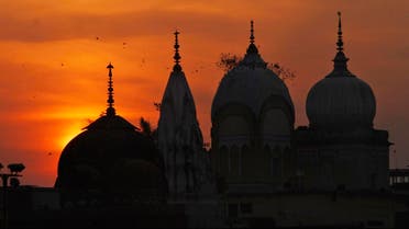 Birds fly at sunset over a Hindu temple on the 20th anniversary of the Babri mosque demolition in Ayodhya, India, on Dec. 6, 2012. (AP)
