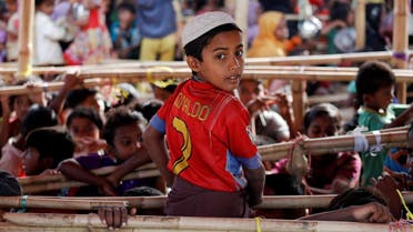 Mohammad Alam, a 10-year-old Rohingya refugee, poses in a T-shirt of his favorite player Cristiano Ronaldo as he joins other children waiting for food to be distributed at Tengkhali camp, near Cox's Bazar, Bangladesh December 7, 2017. (Reuters)