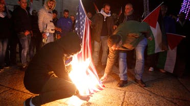Palestinian demonstrators burn the US flag in Bethlehem’s Manger Square in protest to the declaration of the US president declaring Jerusalem as Israel’s capital on December 6, 2017. (AFP)