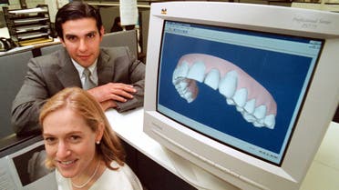Kelsey Wirth, president of Align Technology, bottom, and CEO, Zia Chishti, show off their company’s technology used to straighten teeth, at their offices in Mt. View, Calif., on Sept. 15, 2000. (AP)