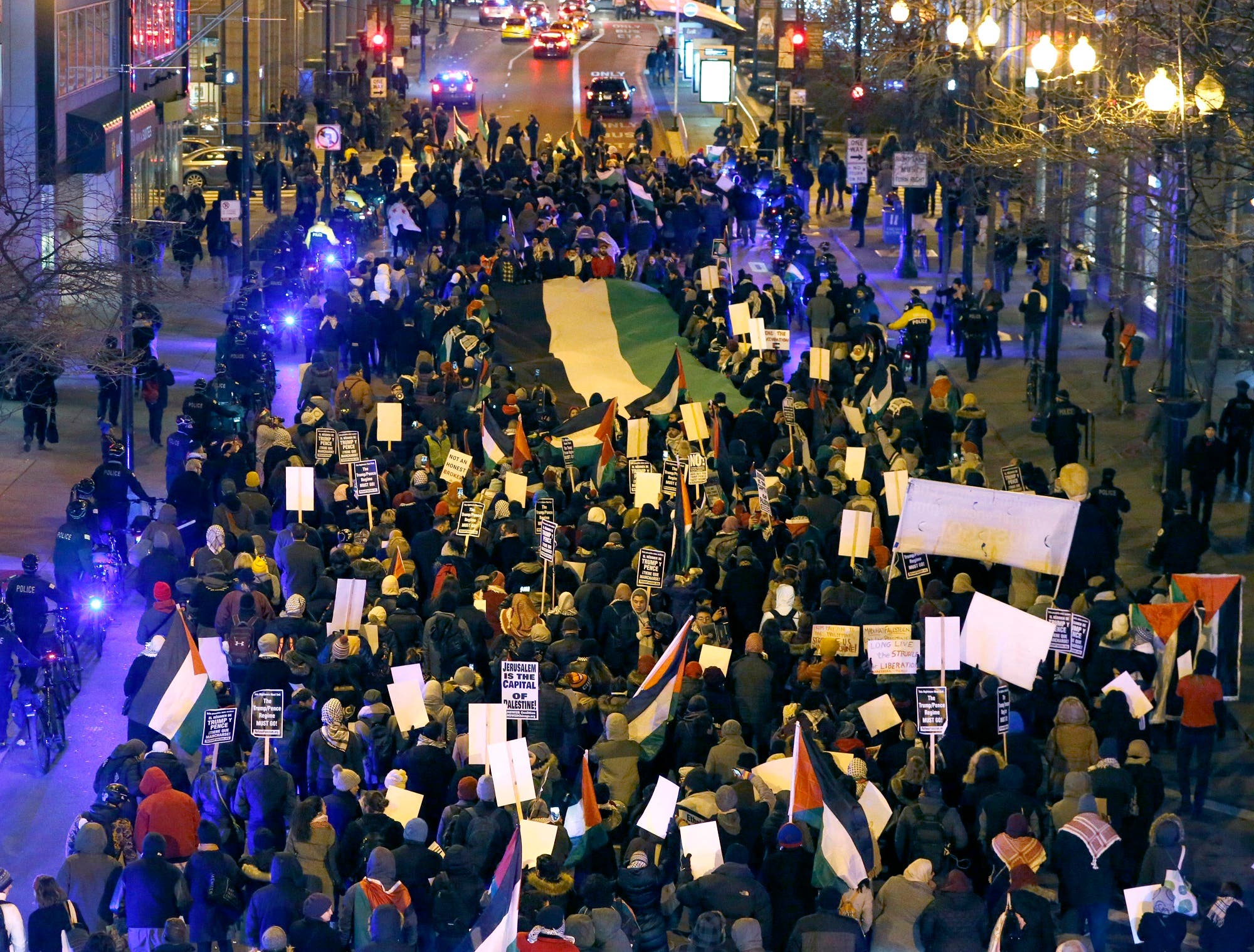 Protesters carry a large Palestinian flag as they march through the streets of Chicago’s famed Loop to protest President Trump’s announcement declaring US support for Jerusalem as the capital of Israel. (AP)