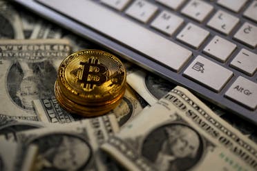 Bitcoin coins placed on Dollar banknotes, next to computer keyboard, are seen in this illustration picture, November 6, 2017. (Reuters)