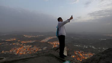 A pilgrim takes a mobile photo at Mount Al-Noor in Mecca on August 28, 2017. (Reuters)