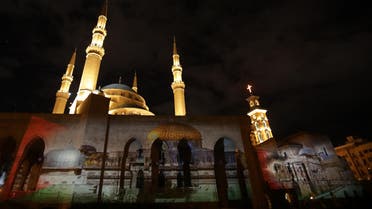 Mohammed al-Amin mosque and the Christian Maronite cathedral in Beirut illuminated with a photograph of al-Aqsa mosque on December 7, 2017. (AFP)