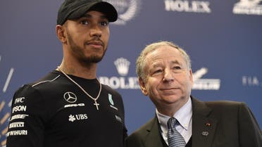 World's Formula One British driver Lewis Hamilton (L) poses next to the President of the FIA Jean Todt during a press conference in Paris on December 8, 2017. (AFP)