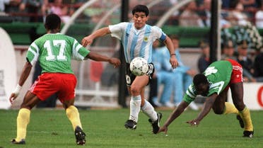 Diego Maradona juggles with the ball as he runs past Cameroon’s Benjamin Massing during the World Cup opening soccer match between Cameroon and Argentina June 8, 1990 in Milan. Cameroon upset the defending world champions 1-0. (AFP)
