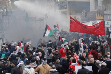 Protesters are sprayed with water near the U.S. embassy in Awkar east of Beirut, Lebanon December 10,2017. (Reuters)