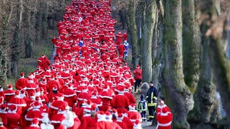 More than a thousand Santas run through streets of German town
