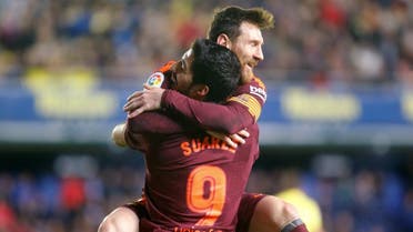 Barcelona’s Lionel Messi celebrates scoring their second goal with Luis Suarez. (Reuters)