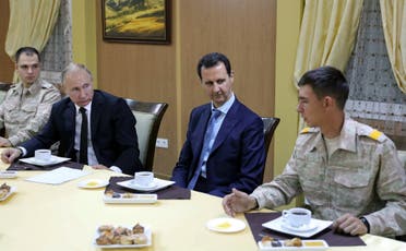 President Putin and Bashar al-Assad with Russian military officers at the Russian air base in Hmeimim, Latakia, on December 11, 2017. (AFP)