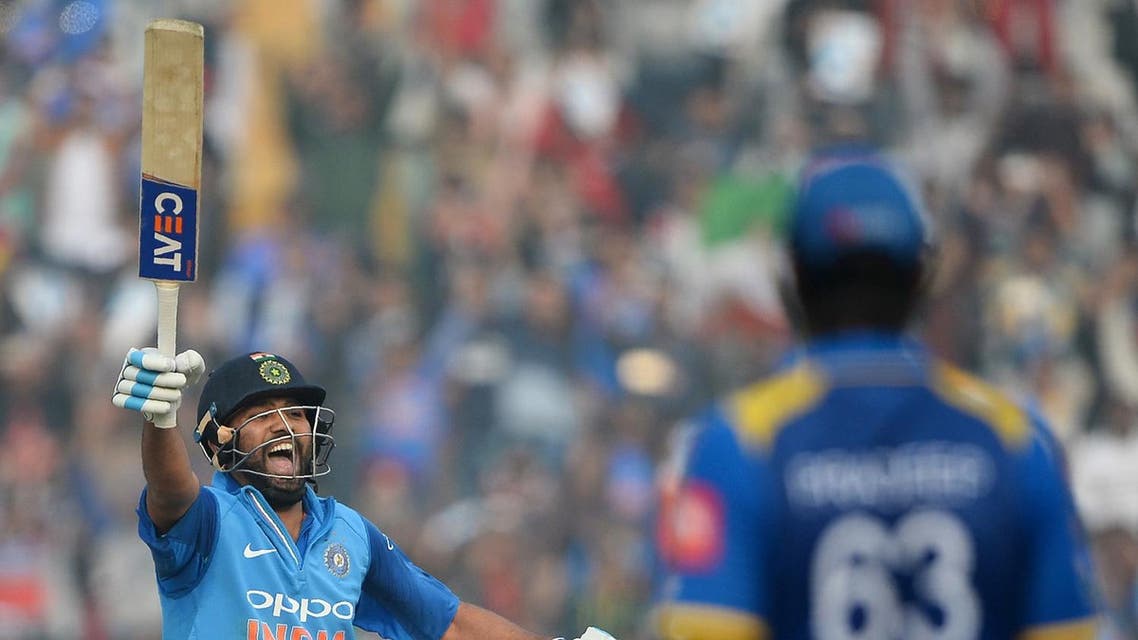 Indian cricket batsman and team captain Rohit Sharma celebrates after completing his double century (200 runs) during the second One Day International (ODI) cricket match between India and Sri Lanka in Mohali on December 13, 2017. (AFP)