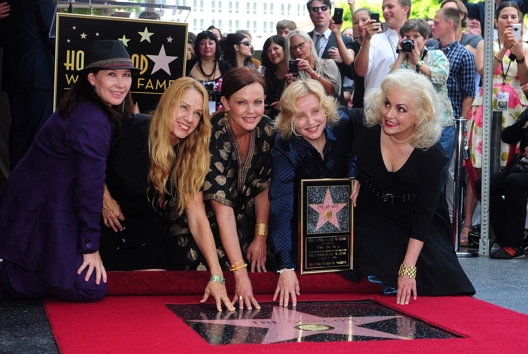 The all-female rock band The Go-Go’s pose beside their star on Hollywood’s Walk of Fame on August 11, 2011 in Hollywood. (AFP)