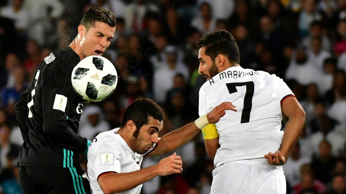 Real Madrid's Portuguese forward Cristiano Ronaldo (left) vies for the header with al-Jazira's Emirati defender Musallem Fayez (center) and Emirati forward Ali Mabkhout (right) during the FIFA Club World Cup semi-final match in the Emirati capital Abu Dhabi on December 13, 2017. (AFP)