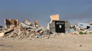 A destroyed building with a wall painted with the black flag commonly used by Islamic State militants, is seen in the town of al-Alam March 10, 2015. (Reuters)