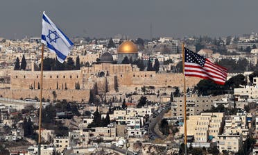 Israeli and US flags placed on the roof of an Israeli settlement building in East Jerusalem on December 13, 2017. (AFP)