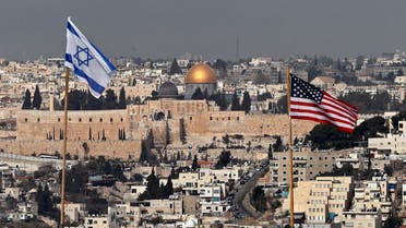 Israeli and US flags placed on the roof of an Israeli settlement building in East Jerusalem on December 13, 2017. (AFP)