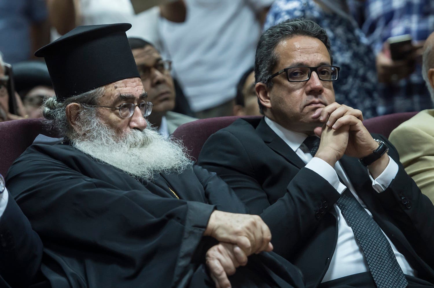 Egyptian Minister of Antiques Khaled el-Anany (R) and Archbishop Damianos of Sinai and Raithu attend a press conference at the Ministry of Antiquities in Cairo on July 4, 2017, to unveil a manuscripts discovered at Saint Catherine Monastery. (AFP)