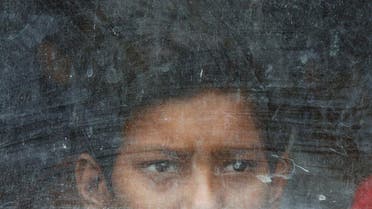 A child labourer looks out from a vehicle after being rescued during a joint operation by police and a non-governmental organisation (NGO) on World Day Against Child Labour in New Delhi June 12, 2009. (Reuters)