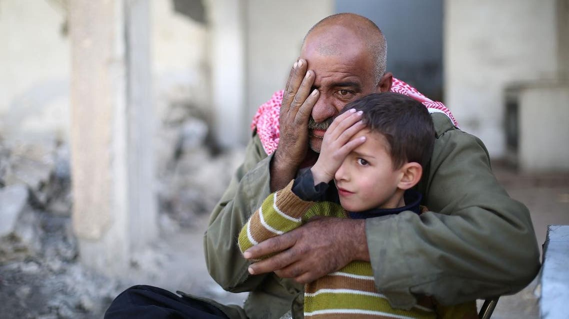 Syrians pose covering one eye with their hands in the rebel-held town of Douma in Syria's besieged eastern Ghouta region. (AFP)