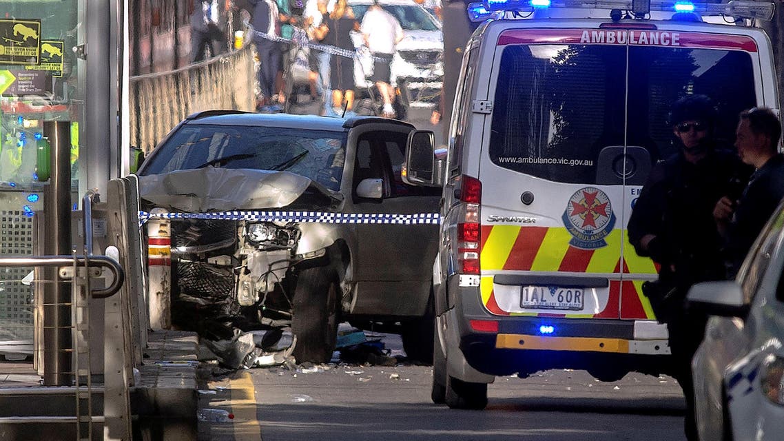 Australian police stand near the crashed vehicle after they arrested the driver. (Reuters)