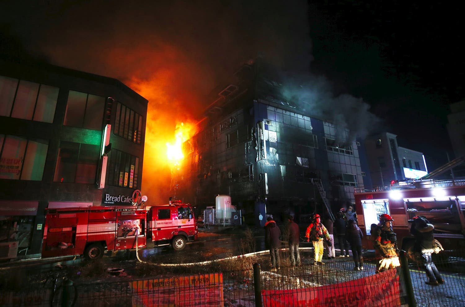 lames and smoke billow from an eight-storey building after a fire broke out in Jecheon, 120 kilometers southeast of Seoul, on December 21, 2017. (AFP)