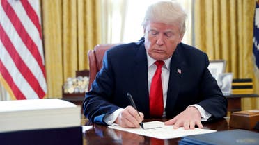 US President Donald Trump signs the $1.5 trillion tax overhaul plan in the Oval Office of the White House in Washington, on December 22, 2017. (Reuters)
