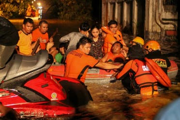 Rescue workers evacuate flood-affected residents in Davao on the southern Philippine island of Mindanao early on December 23, 2017, after Tropical Storm Tembin dumped torrential rains across the island. (AFP)
