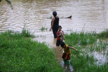 Villagers wade through a flooded street in Borongan on eastern Samar in the Philippines. (AFP)