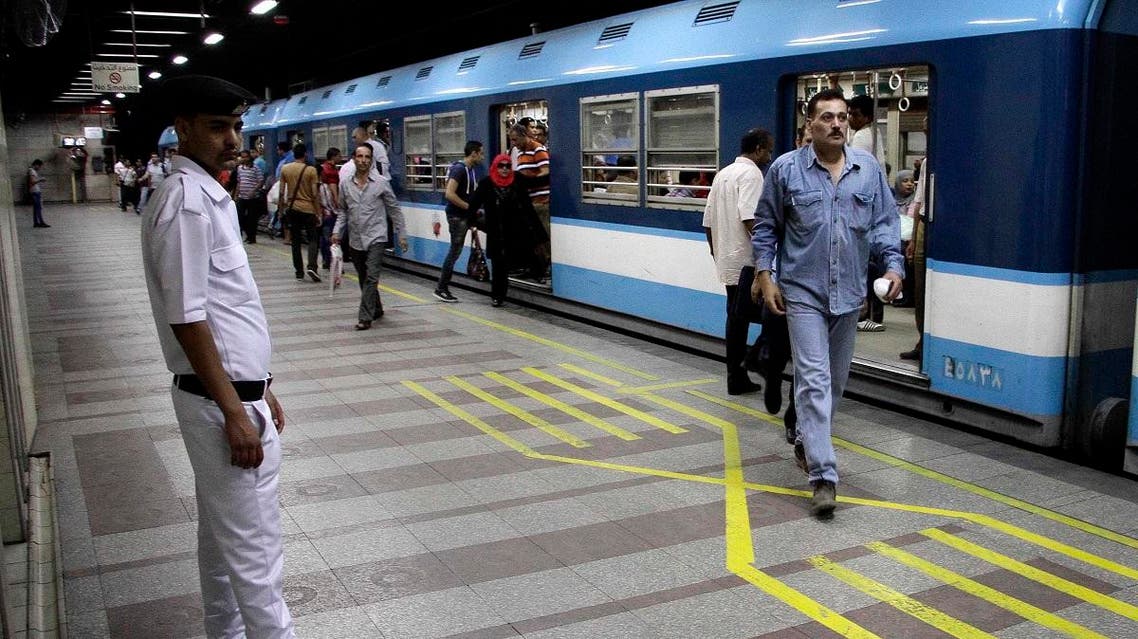 An Egyptian policeman stands guard at the "Anwar Sadat" metro station in the landmark Tahrir Square. (AFP)