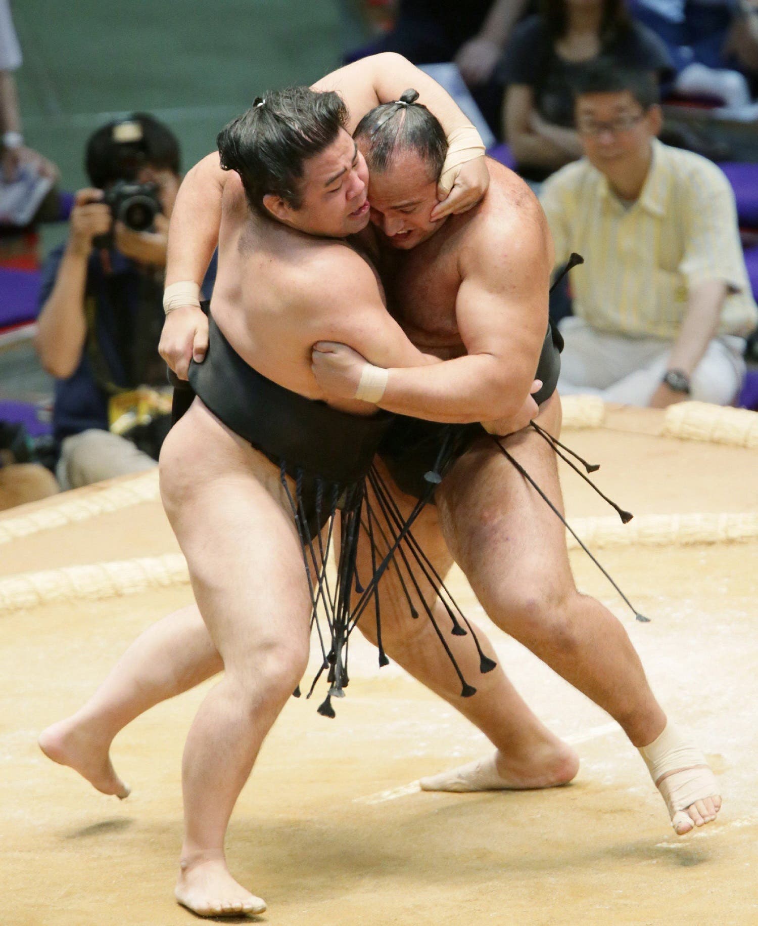 Osunaarashi pushes Satoyama (L) out of the ring during the second-day bout of the Nagoya Grand Sumo Tournament in Nagoya on July 8, 2013. (AFP)