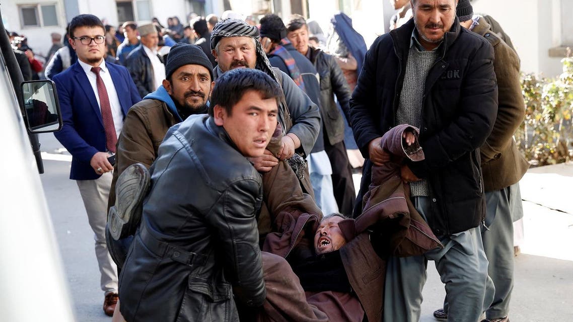 People carry a mourning man at a hospital after a suicide attack in Kabul, Afghanistan December 28, 2017. (Reuters)