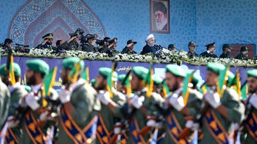 Iran’s President Hassan Rouhani reviews army troops marching in front of the shrine of Ayatollah Khomeini, just outside Tehran on Sept. 22, 2017. (AP)